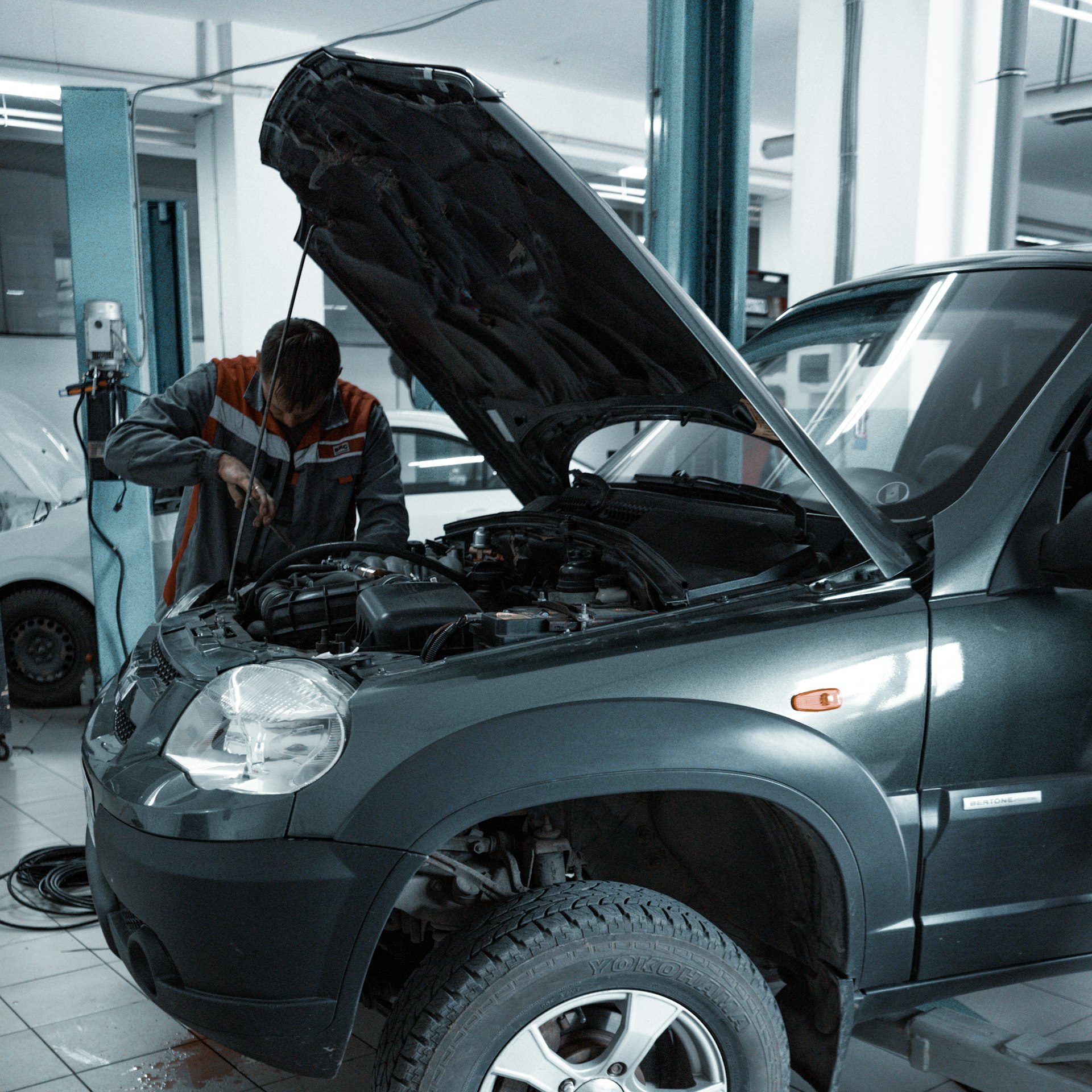 A technician servicing a vehicle at Capital Drive Motors